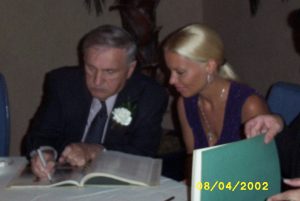 George Barris signs a book for IM member Kim Smith in 2002.